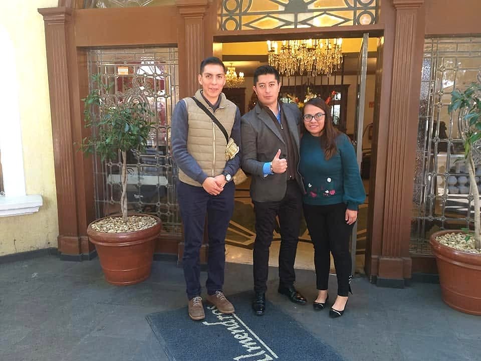Three team members at the entrance of a restaurant.