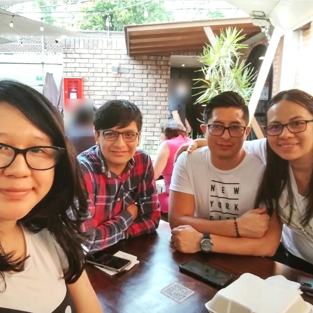 Four team members at a table on a terrace.